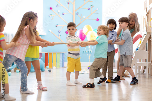 Group of children in a rope-pulling contest in daycare