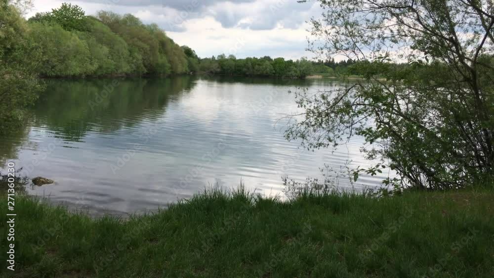 Pan over beautiful peaceful lake in summer Pan over beautiful peaceful lake in summer