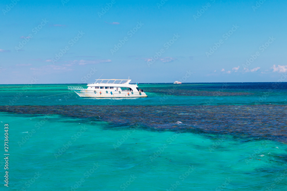 White yacht anchored near coral reef in Red sea, Egypt White yacht anchored near coral reef in Red sea, Egypt