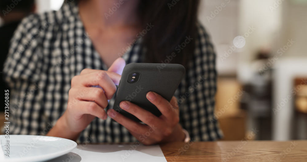 Woman use of mobile phone order in restaurant Woman use of mobile phone order in restaurant