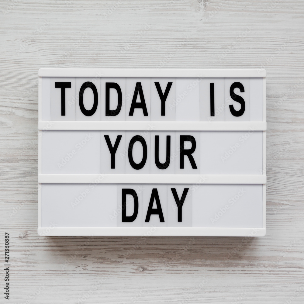 Light box with 'Today is your day' words on a white wooden background, top view. Flat lay, overhead, from above. Closeup. Light box with 'Today is your day' words on a white wooden background, top view. Flat lay, overhead, from above. Closeup.