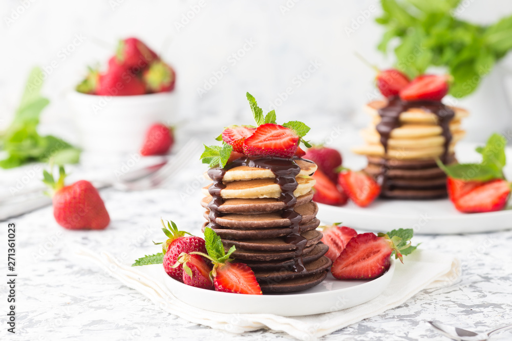 Homemade pancakes with chocolate topping and strawberries 