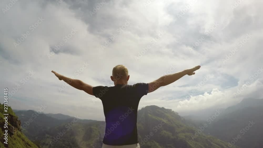 4K male walking up to top of mountain and spreading his hands 4K male walking up to top of mountain and spreading his hands