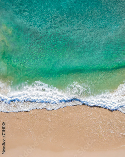 Aerial top shot of a beach with nice sand, blue turquoise water and tropical vibe © FRPhotos