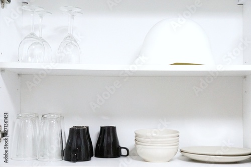 white cupboard with kitchenware accessories ready for use