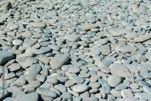 Pebble beach on a sunny summer day, background, selective focus