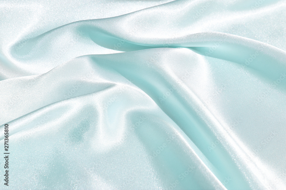 Fototapeta premium The texture of the satin fabric of green color for the background