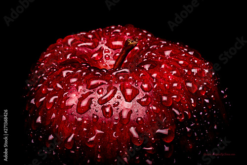 Photography A Frame filling Macro image of a vibrant Red apple covered in water drops beading on the peel