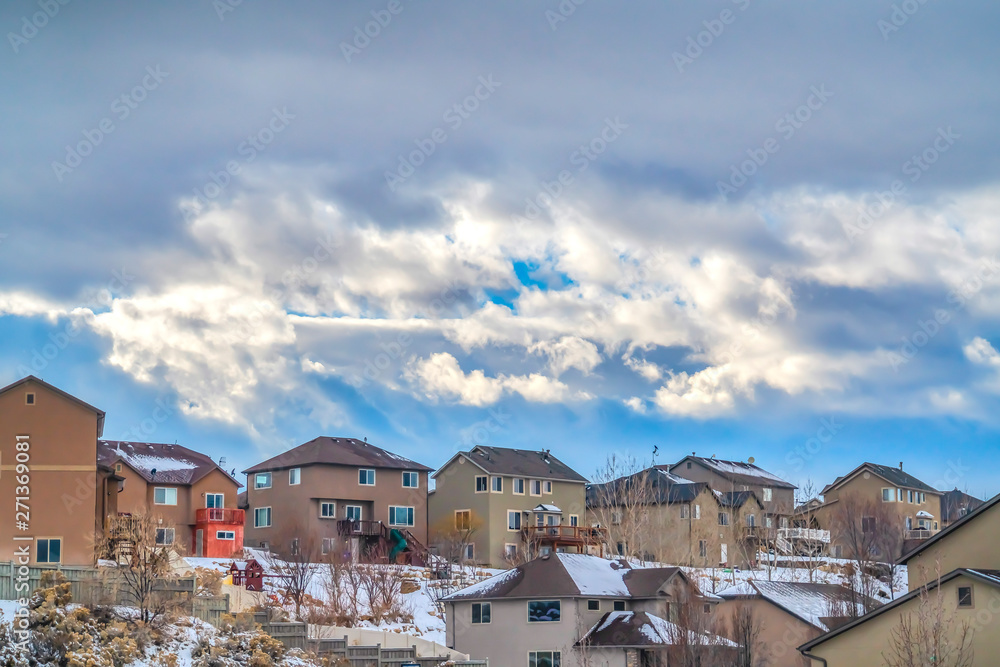 Houses on a hill covered with powdery white snow during winter season