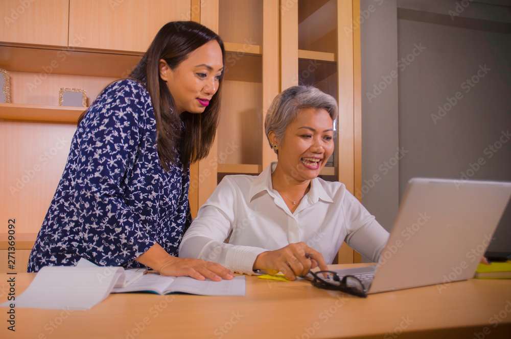 natural lifestyle portrait of two business partners or work colleagues women collaborating and coworking happy and cheerful at office laptop computer desk natural lifestyle portrait of two business partners or work colleagues women collaborating and coworking happy and cheerful at office laptop computer desk
