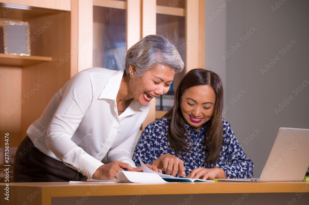 Fototapeta premium business partners women collaborating and coworking happy and successful at office laptop computer desk in job female colleagues cooperation and success