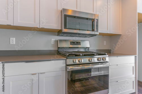 Obraz na płótnie Cooking range and wall mounted microwave inside a modern kitchen