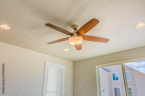 Ceiling fan with wooden five blade design and built in light photo