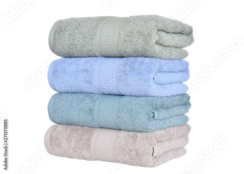 CLOSE UP OF STACKED SOFT AND COLOR COTTON BATH TOWEL. COTTON TOWEL ISOLATED.
