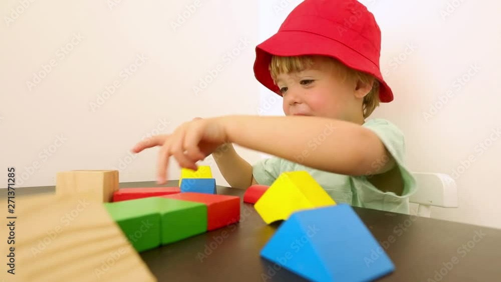 Cute little boy playing with blocks at home Cute little boy playing with blocks at home