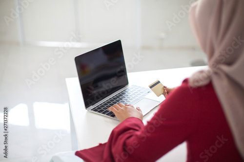 Young beautiful asian muslim woman working with computer  Tablet and calculator