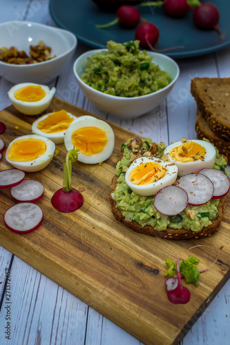 Sandwiches with avocado guacamole  fresh radish and boiled egg