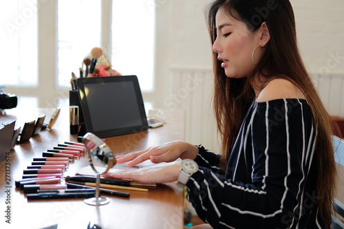 asian woman applying makeup cosmetic