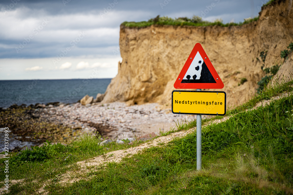 Falling rocks warning sign at danish coastline Stock Photo | Adobe Stock