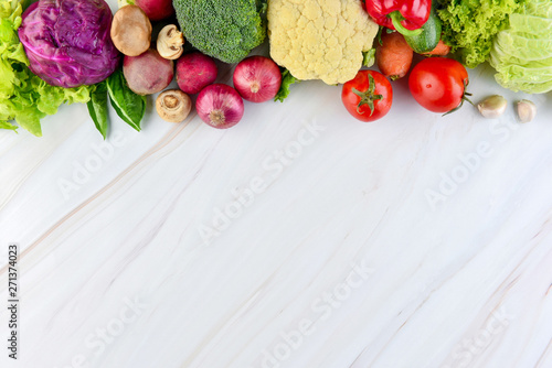 Fresh colorful healthy vegetables on marble countertop background