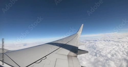 a time lapse of an airplane pulling out of its gate at the airport and taking off from Las Vegas, Nevada, and flying high over the clouds.