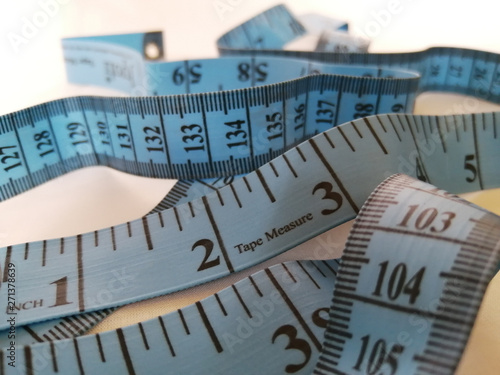 Blue Measuring Tape Isolated on White Background photo