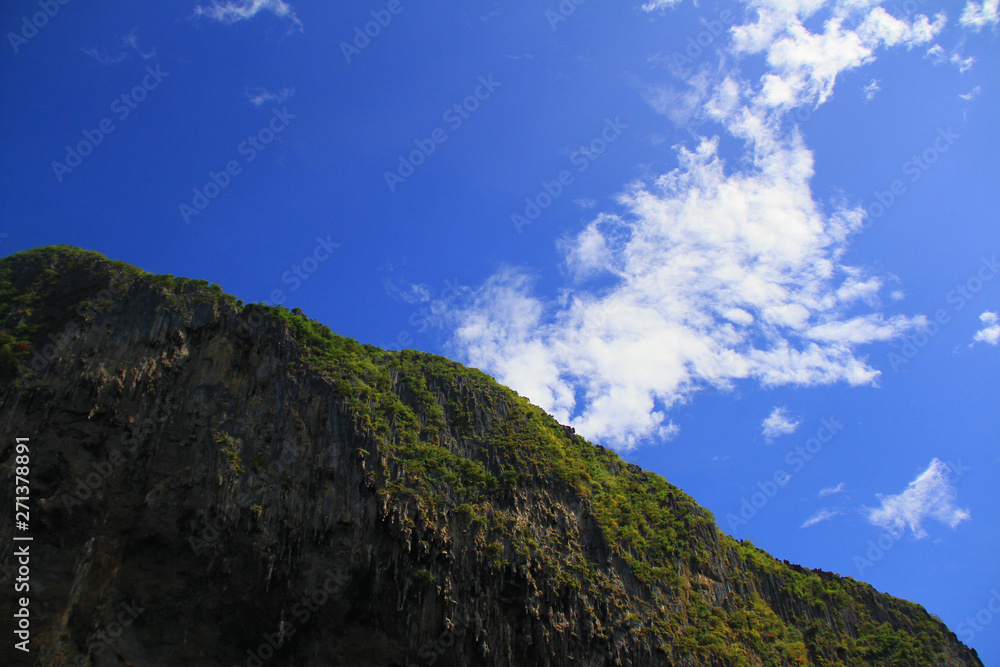 Mountain rock in middle of sea with blue sky and cloud, very happy every time when seeing. Mountain rock in middle of sea with blue sky and cloud, very happy every time when seeing.
