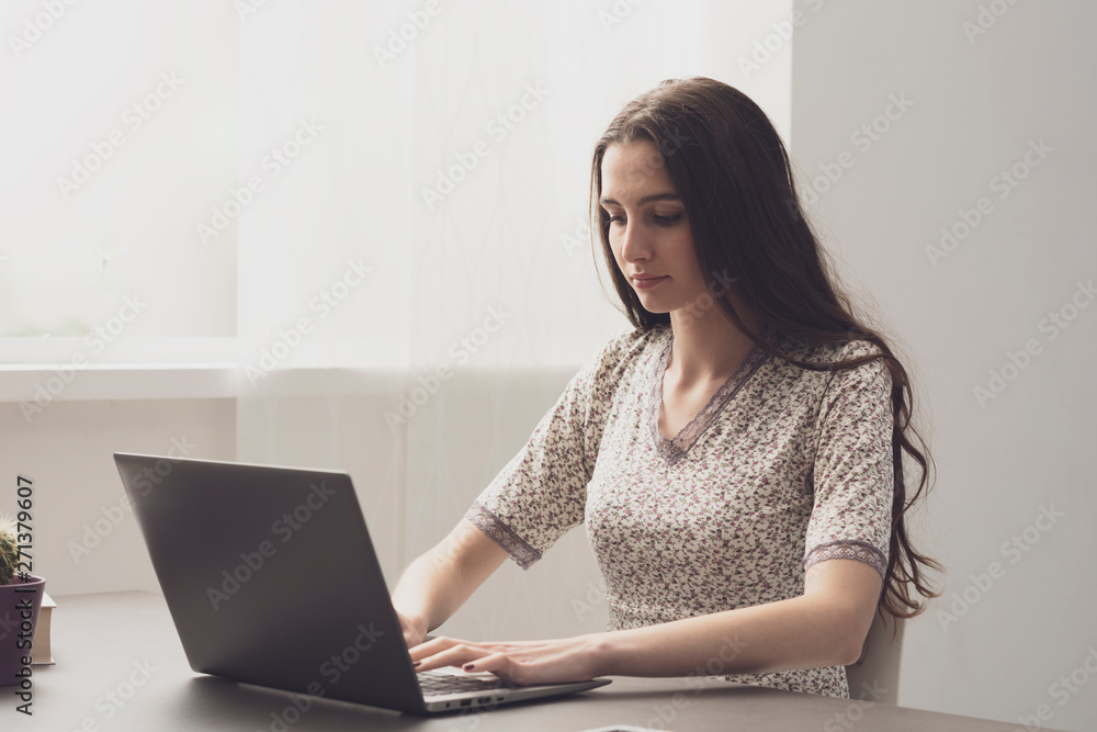 Naklejka premium Young woman working with her laptop at home