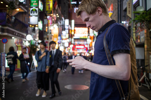 A handsome man looking at his phone