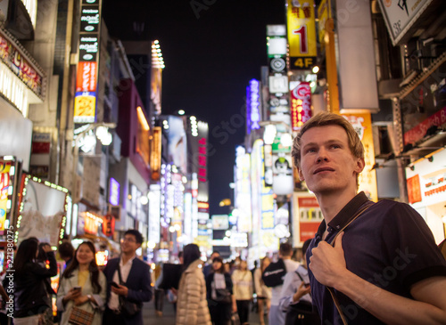 A handsome blond tourist looking of to the front