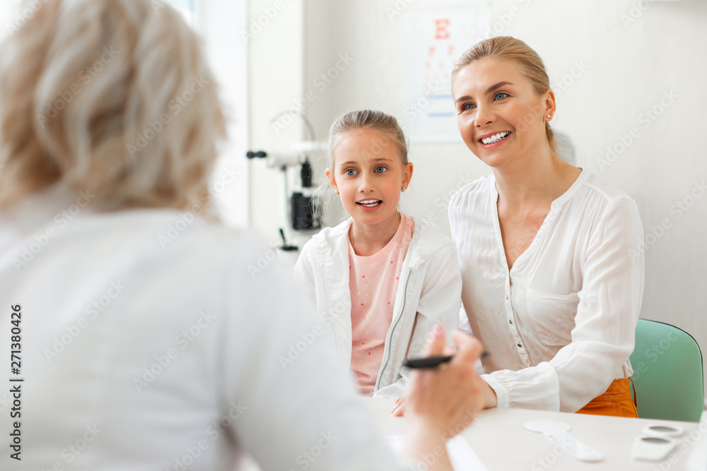 Fototapeta premium Good-looking blonde mother sitting with cute little girl