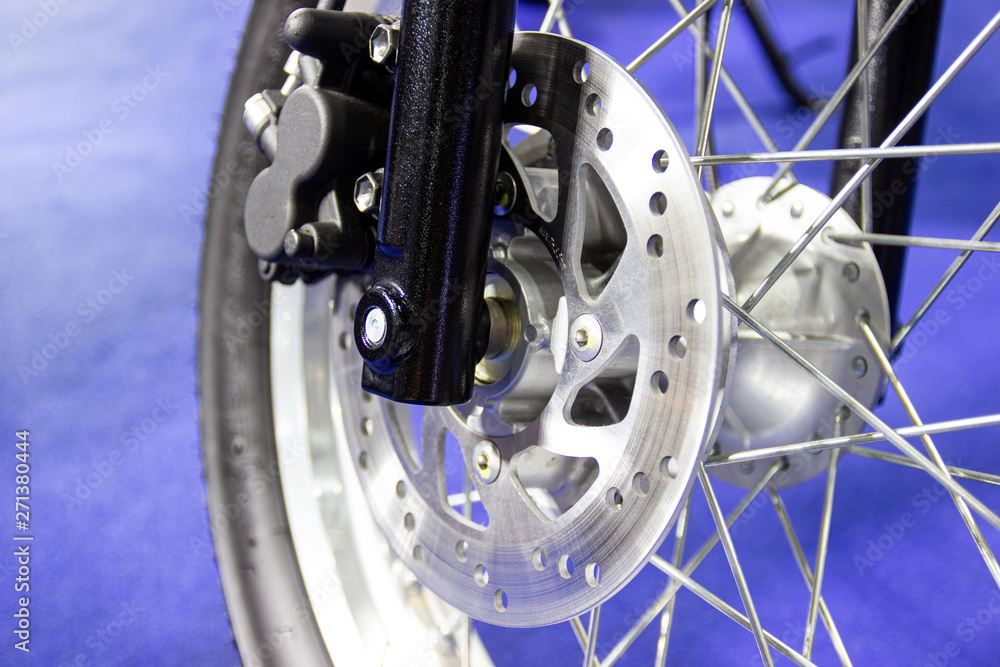 Obraz premium close up - wheel spokes and brake disc of a motorcycle