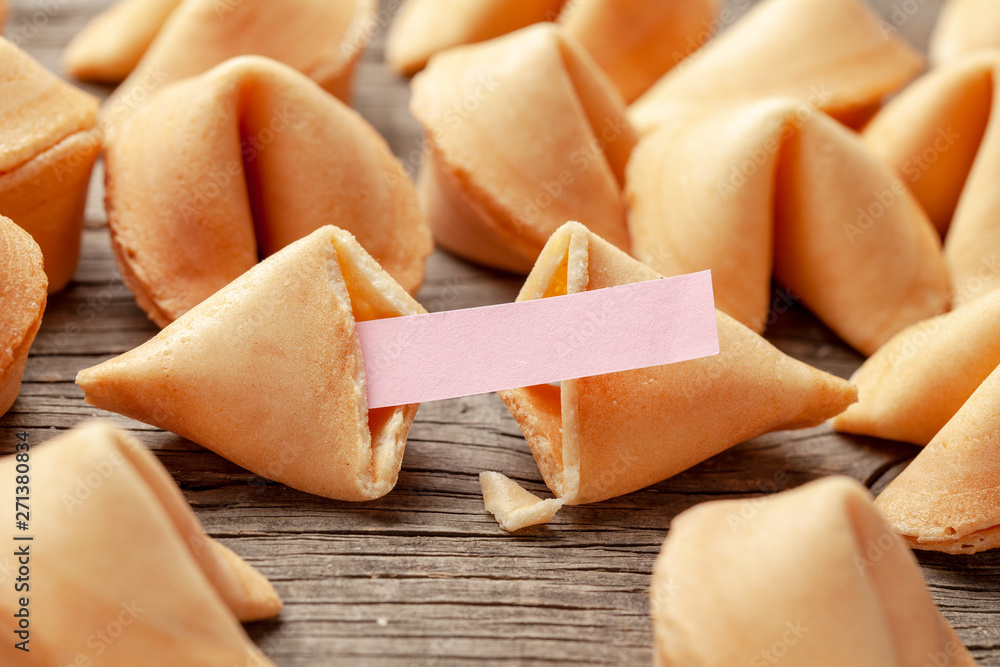 Fototapeta premium Chinese fortune cookies. Cookies with empty blank inside for prediction words. Background of old wooden table.