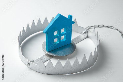 Trap with bait house. The risk of buying an old house. Dangerous mortgage. Home insurance. Gray background.