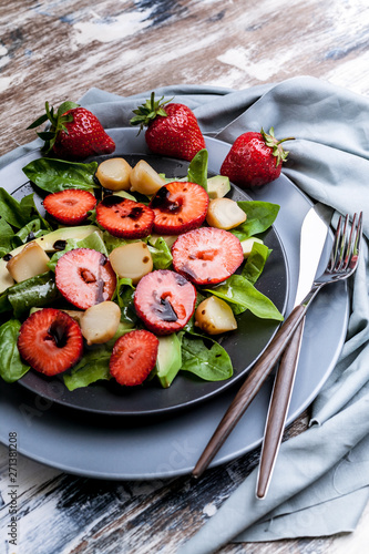 Delicious salad with greens, strawberries and smoked cheese. Tasty and healthy.