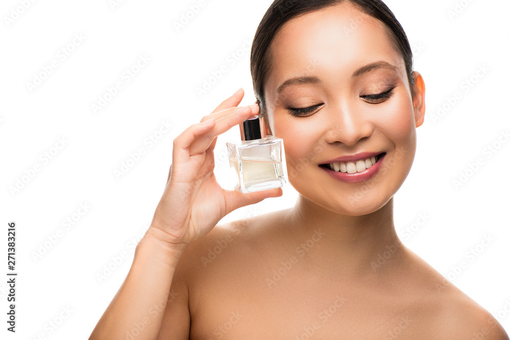 smiling asian woman holding perfume, isolated on white smiling asian woman holding perfume, isolated on white