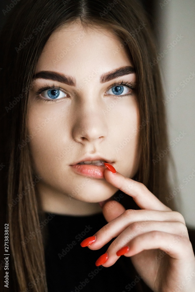Outdoors portrait of beautiful young brunette girl dressed in black clothes. Portrait of a pretty girl Outdoors portrait of beautiful young brunette girl dressed in black clothes. Portrait of a pretty girl