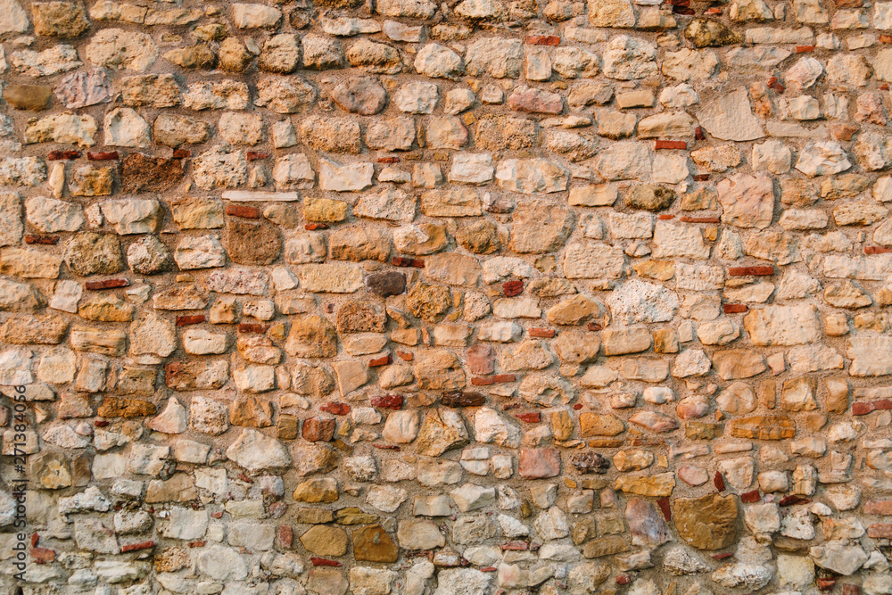 Stone wall of the medieval fortress, Stone background pattern Stone wall of the medieval fortress, Stone background pattern