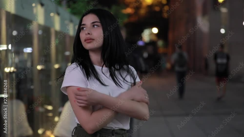 Cute woman walking in fresh cold night city Cute woman walking in fresh cold night city