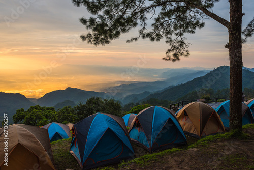 Fototapeta Naklejka Na Ścianę i Meble -  Adventures Camping tourism and tent ,view forest landscape , outdoor in morning and sunset sky at Mon Sone View point , Doi Pha Hom Pok National Park in Chiang Mai, Thailand. Concept Travel.