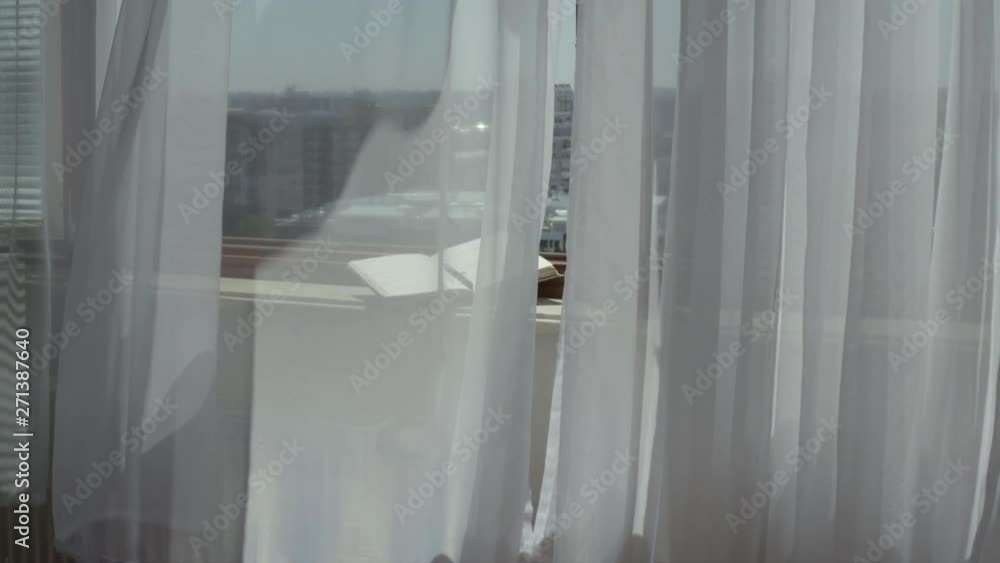 Open agenda with a pen at marble sill of an open window. Blowing grey transparent curtains Open agenda with a pen at marble sill of an open window. Blowing grey transparent curtains