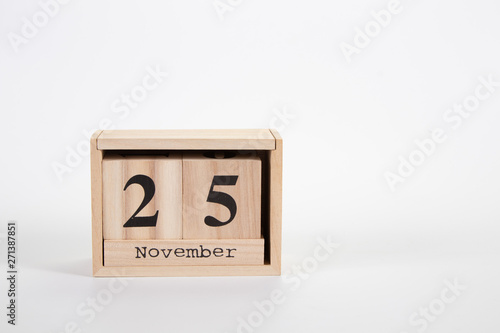 Wooden calendar November 25 on a white background