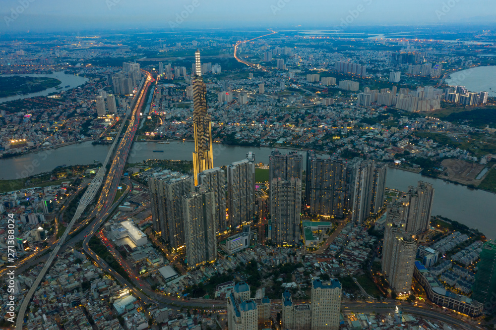 Fototapeta premium Top View of Building in a City - Aerial view Skyscrapers flying by drone of Ho Chi Mi City with development buildings, transportation, energy power infrastructure.