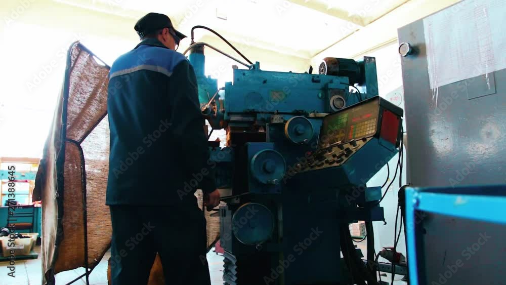 Facing operation of a metal blank on turning machine with cutting tool.Old turning lathe machine in turning workshop. Turning lathe in action Facing operation of a metal blank on turning machine with cutting tool.Old turning lathe machine in turning workshop. Turning lathe in action