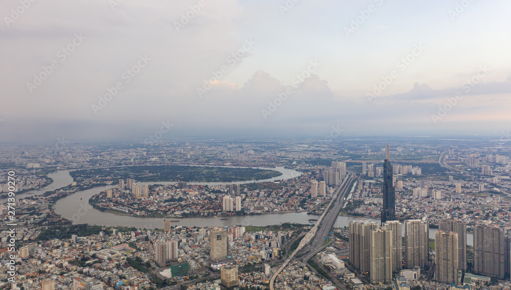 Top View of Building in a City - Aerial view Skyscrapers flying by drone of Ho Chi Mi City with development buildings, transportation, energy power infrastructure.