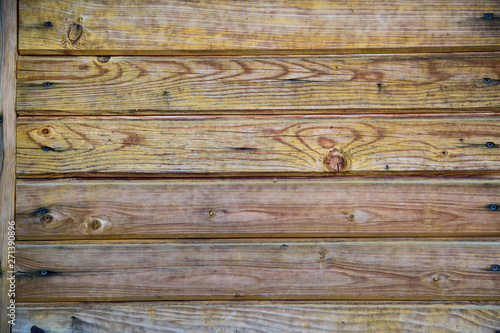 Background of old boards yellow and purple with knots hammered nails. Design backgrounds texture.