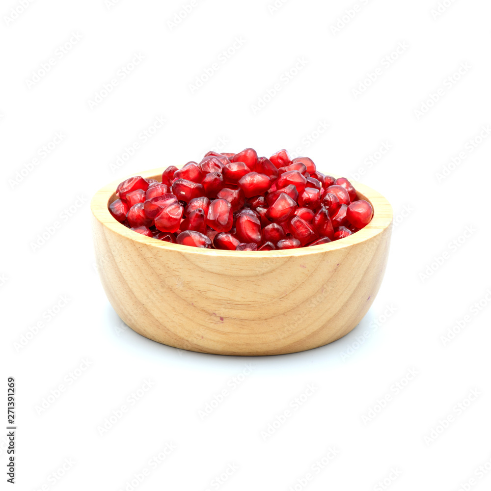 Pomegranate In a wooden cup isolated on the white background. Pomegranate In a wooden cup isolated on the white background.