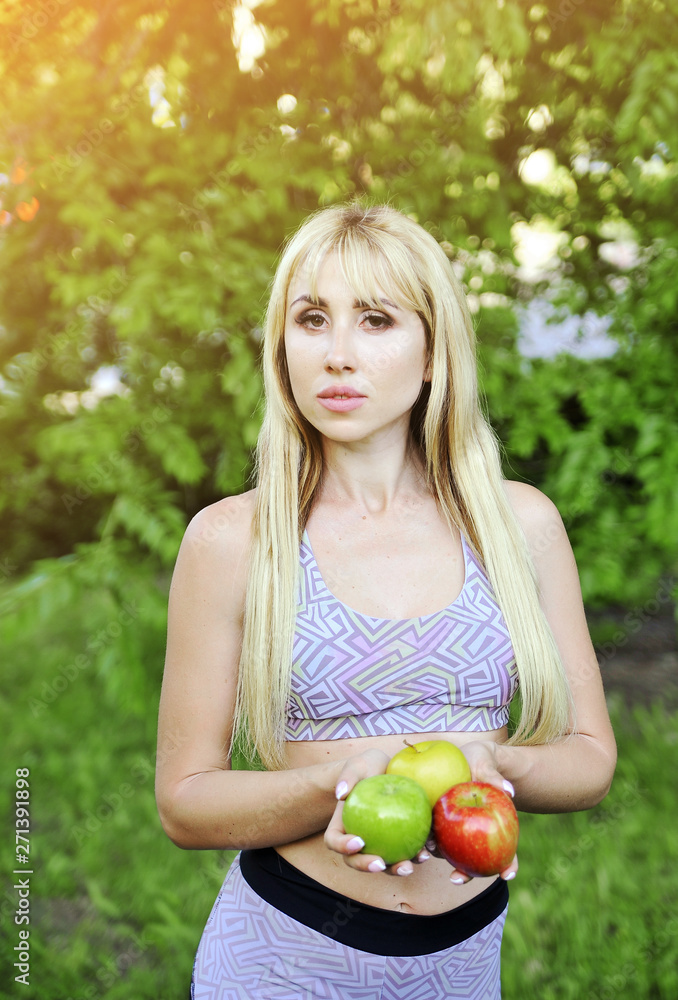 Beautiful fitness woman with apple outdoors. Beautiful fitness woman with apple outdoors.