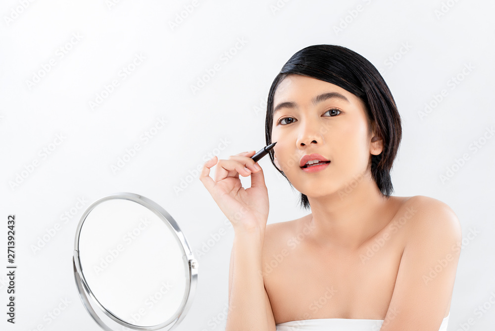 Beautiful young radiant skin Asian woman holding eyeliner makeup Beautiful young radiant skin Asian woman holding eyeliner makeup