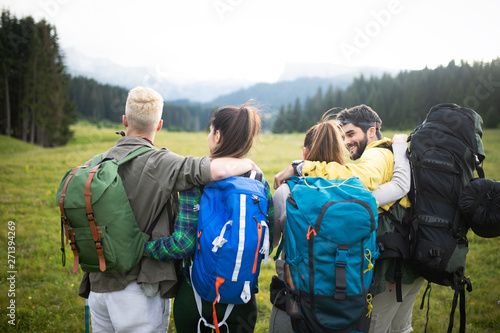 Four happy friends are looking on mountains and having fun together © NDABCREATIVITY